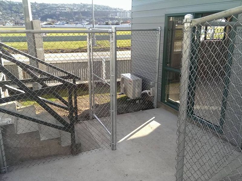 Galvanised chain link security fence and gate enclosing a commercial yard