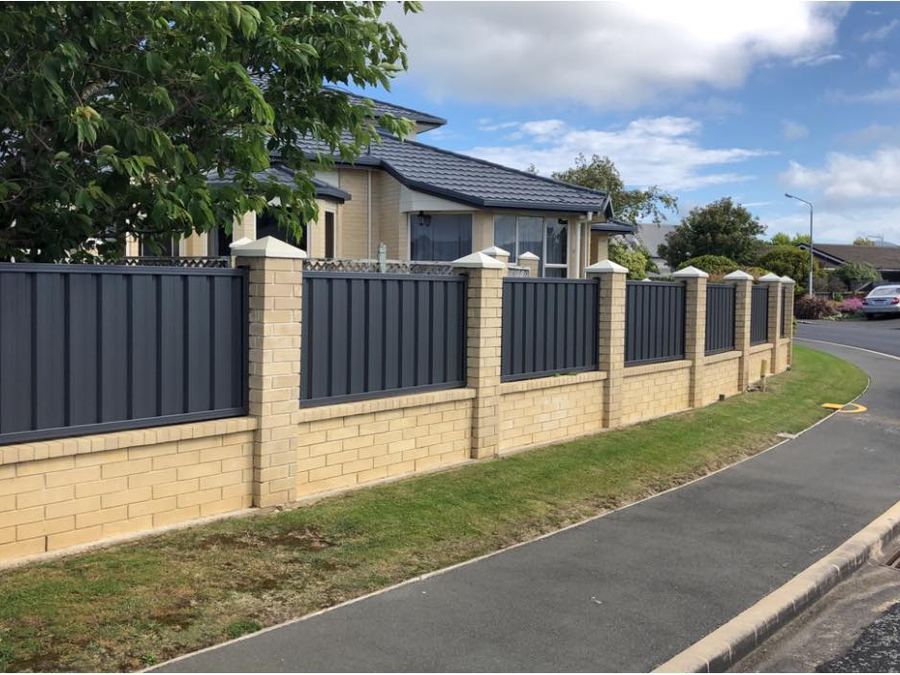 Charcoal colour steel infill panels set between brick pillars along a street frontage