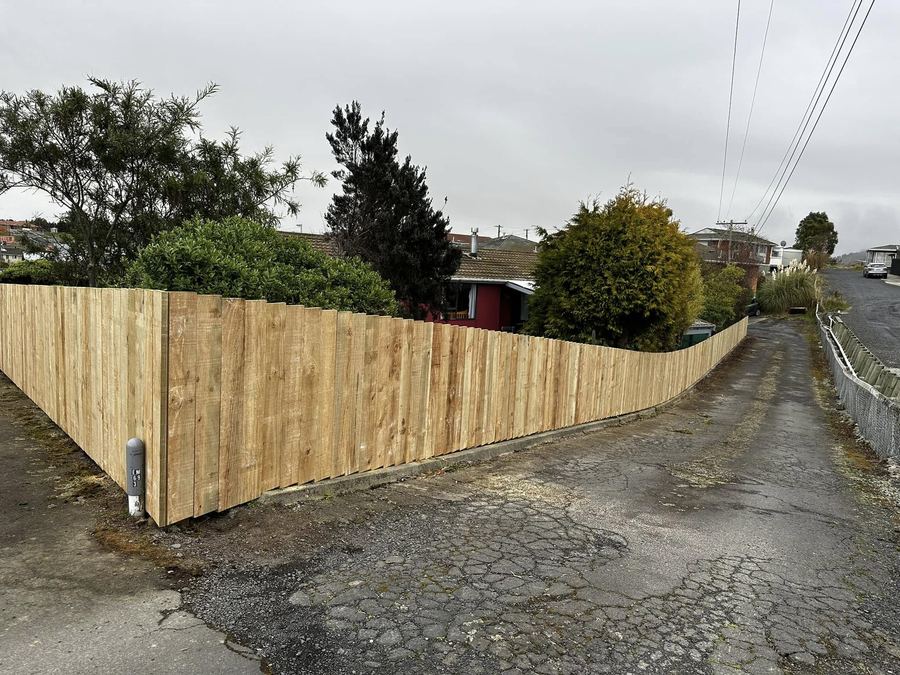 Timber paling fence running the length of a driveway