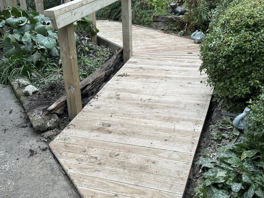 Timber walkway and handrail built through a sloping garden