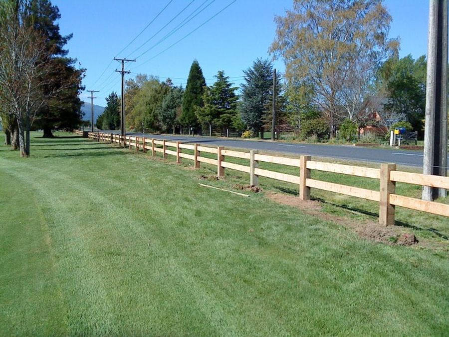 Post and rail fence running the length of a road frontage