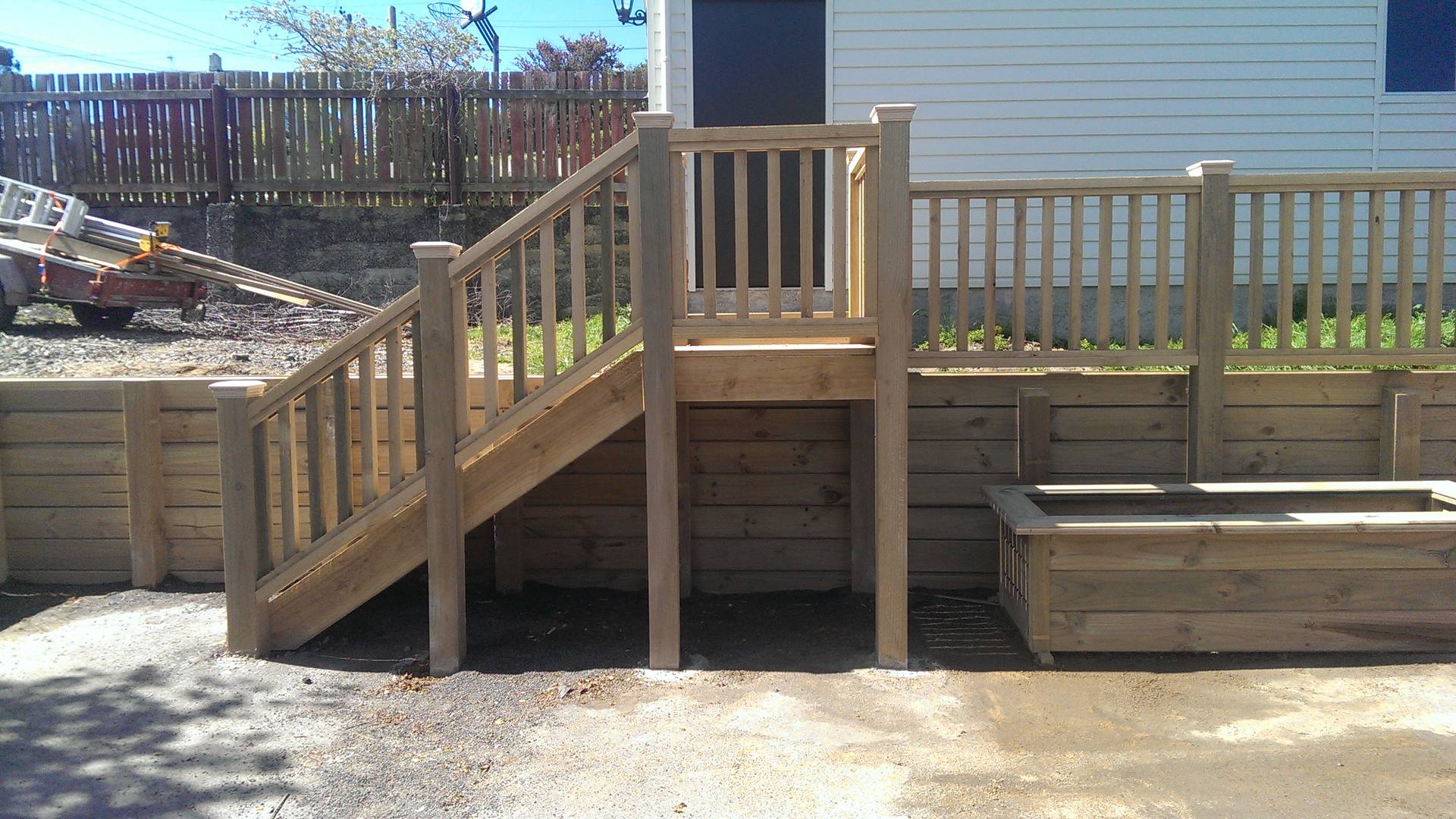 Timber deck with steps and a raised planter box built alongside it