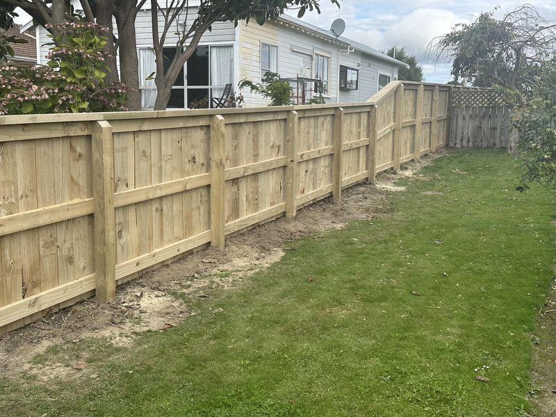 New timber paling fence with rails enclosing a back lawn